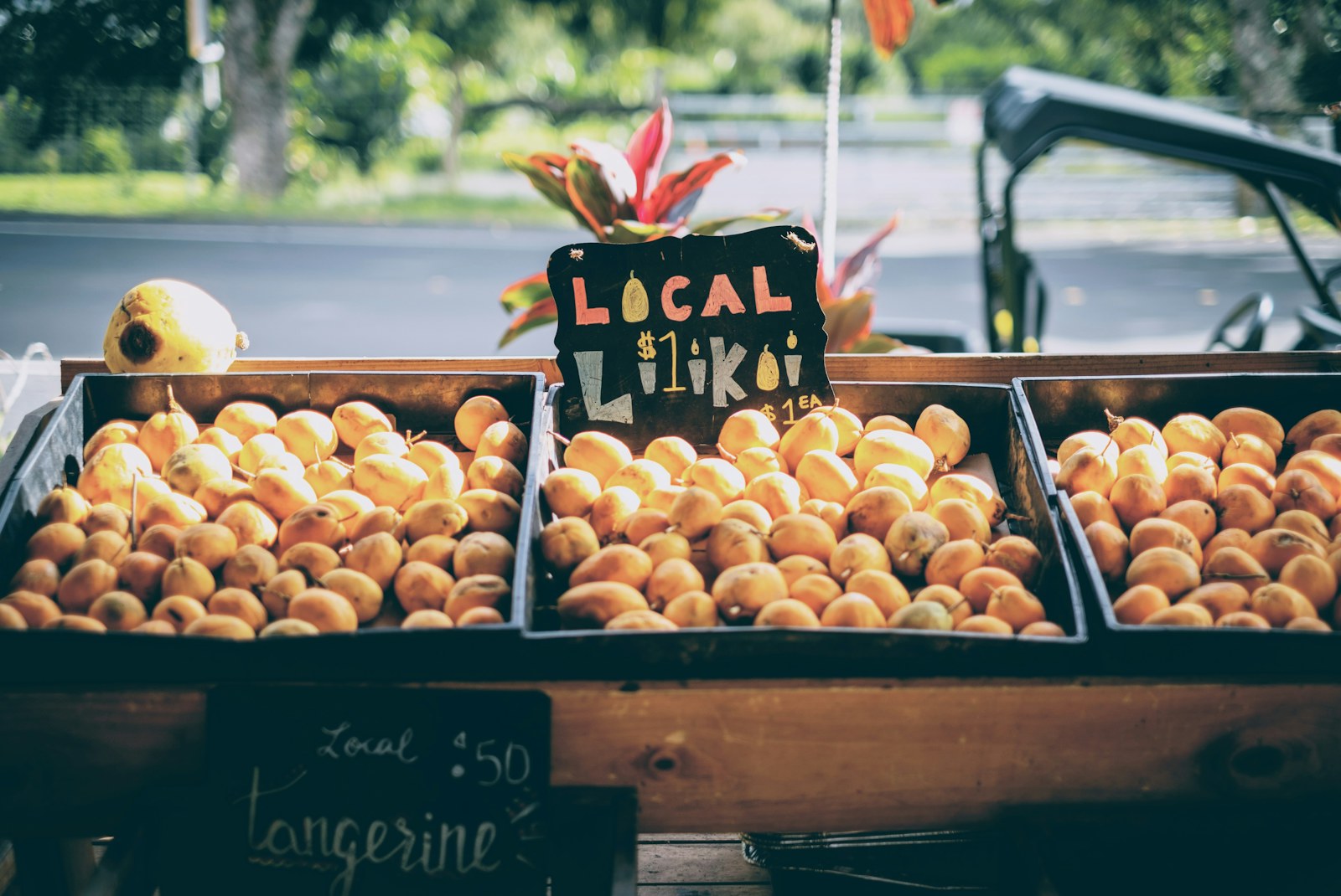 Crates of local lilikoi and tangerines for sale at one of the Kauai farmers markets.
