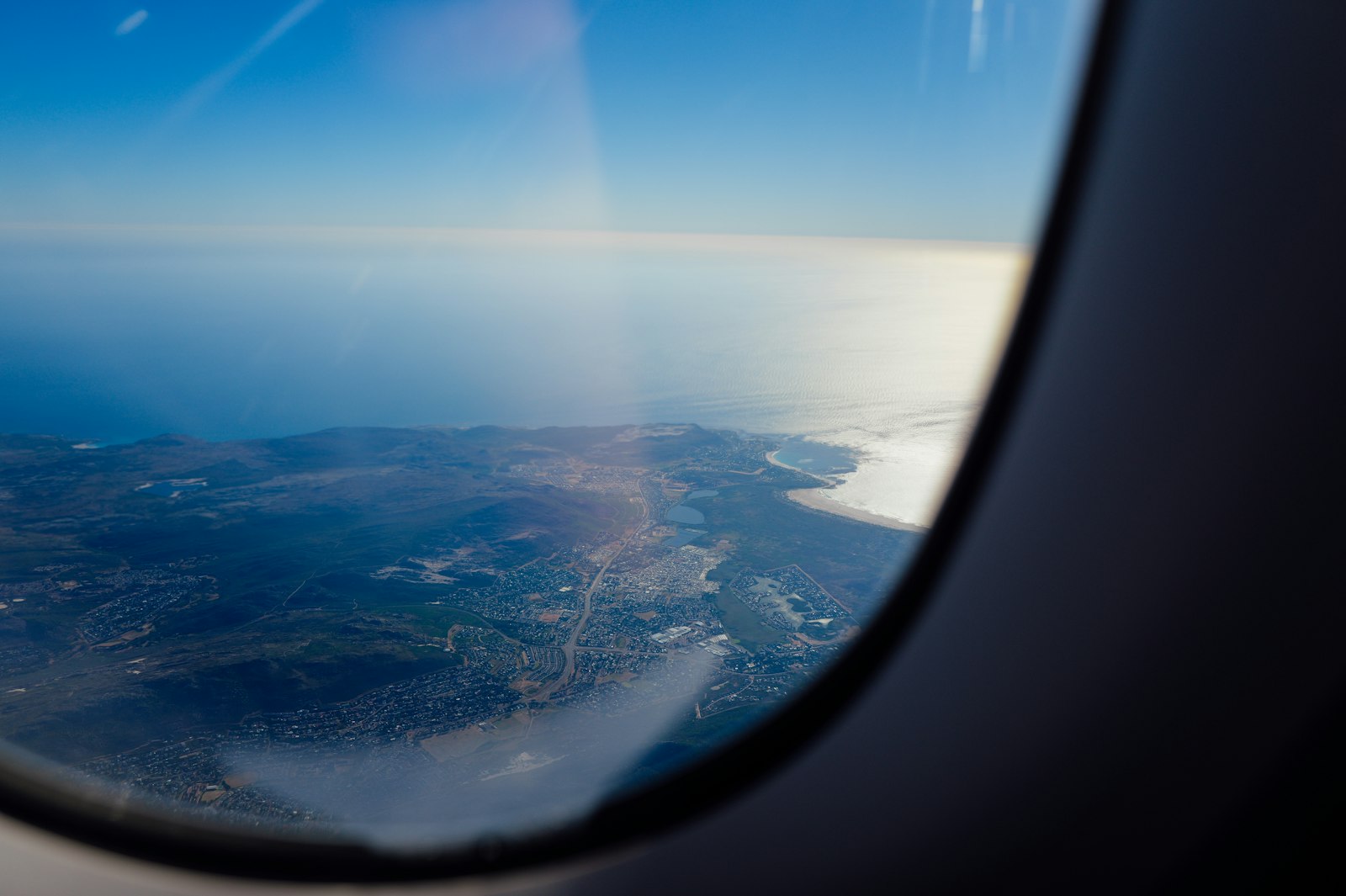A coastline seen from an aeroplane window on the descent.