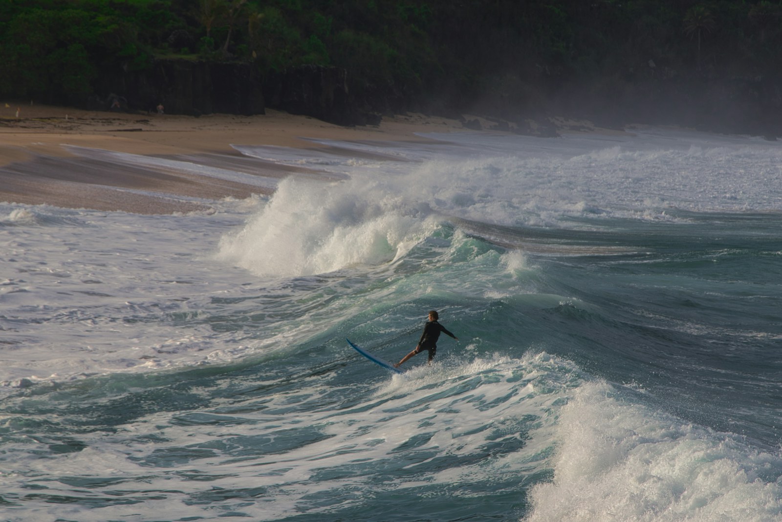 Surfer riding a large winter wave on the North Shore of Oahu