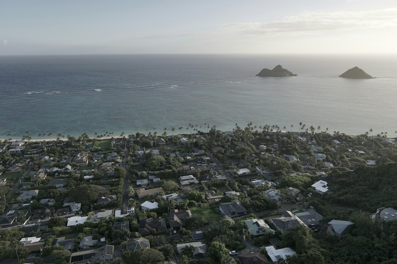 Aerial view of Kailua town on Oahu at dusk with the Mokulua islands offshore, a common landing spot after a PCS to Hawaii.