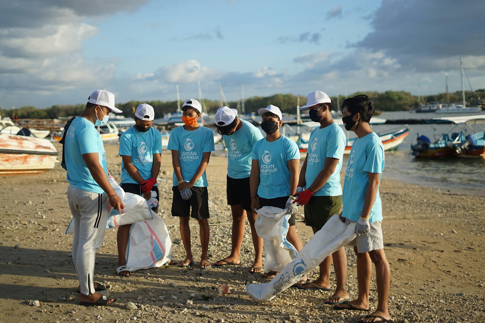 A group of volunteers in matching shirts on a beach