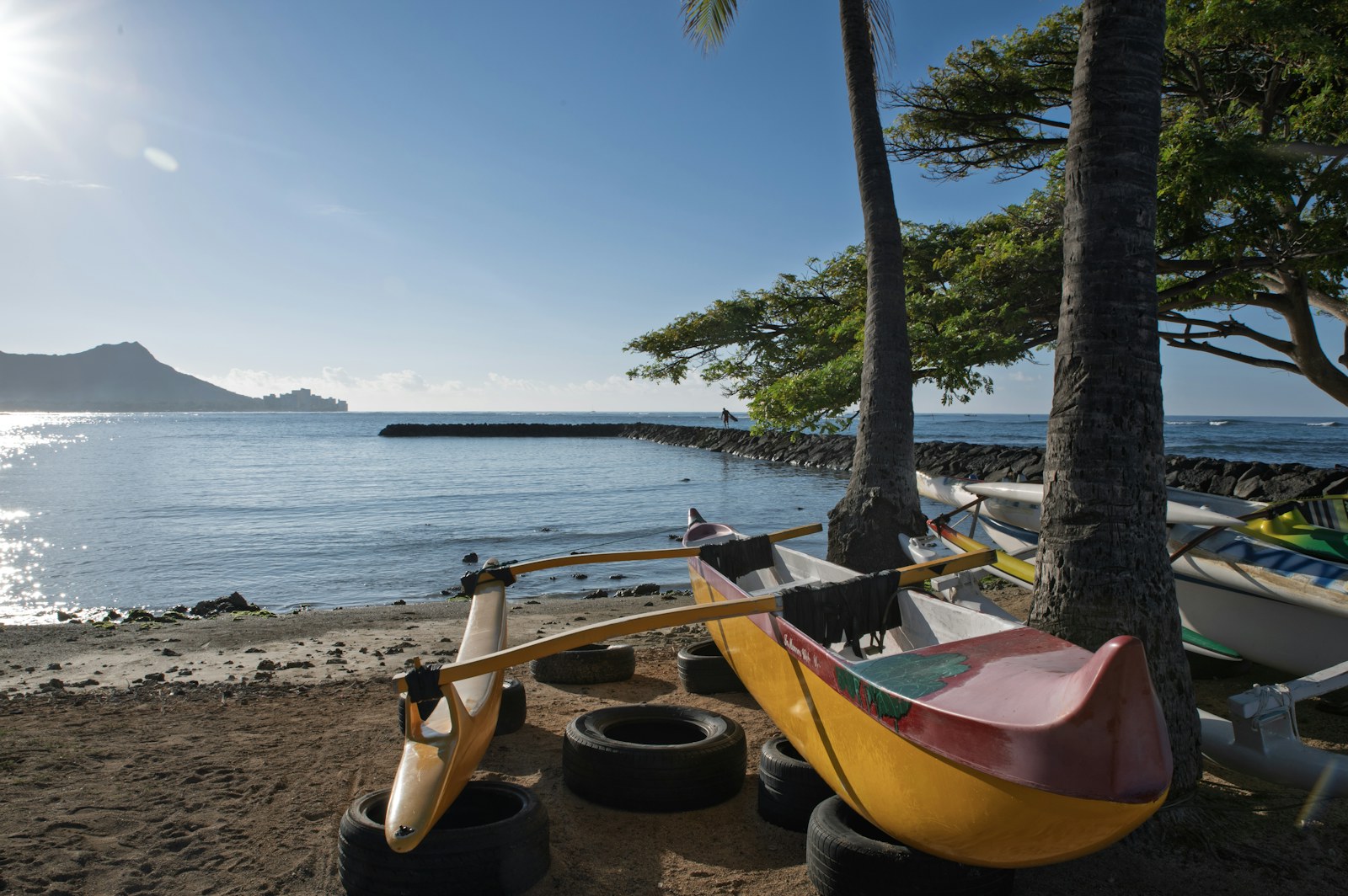 Outrigger canoe on the beach with Diamond Head in the distance, the kind of plan you can join on YKnot.