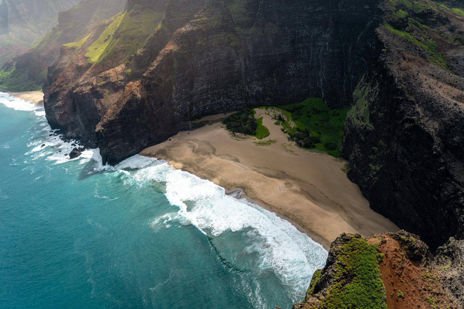 Aerial view of a sandy cove below the Napali cliffs, one of the best beaches on Kauai.