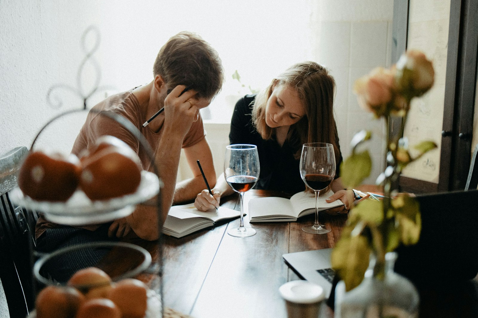 Two people reading and talking across a table