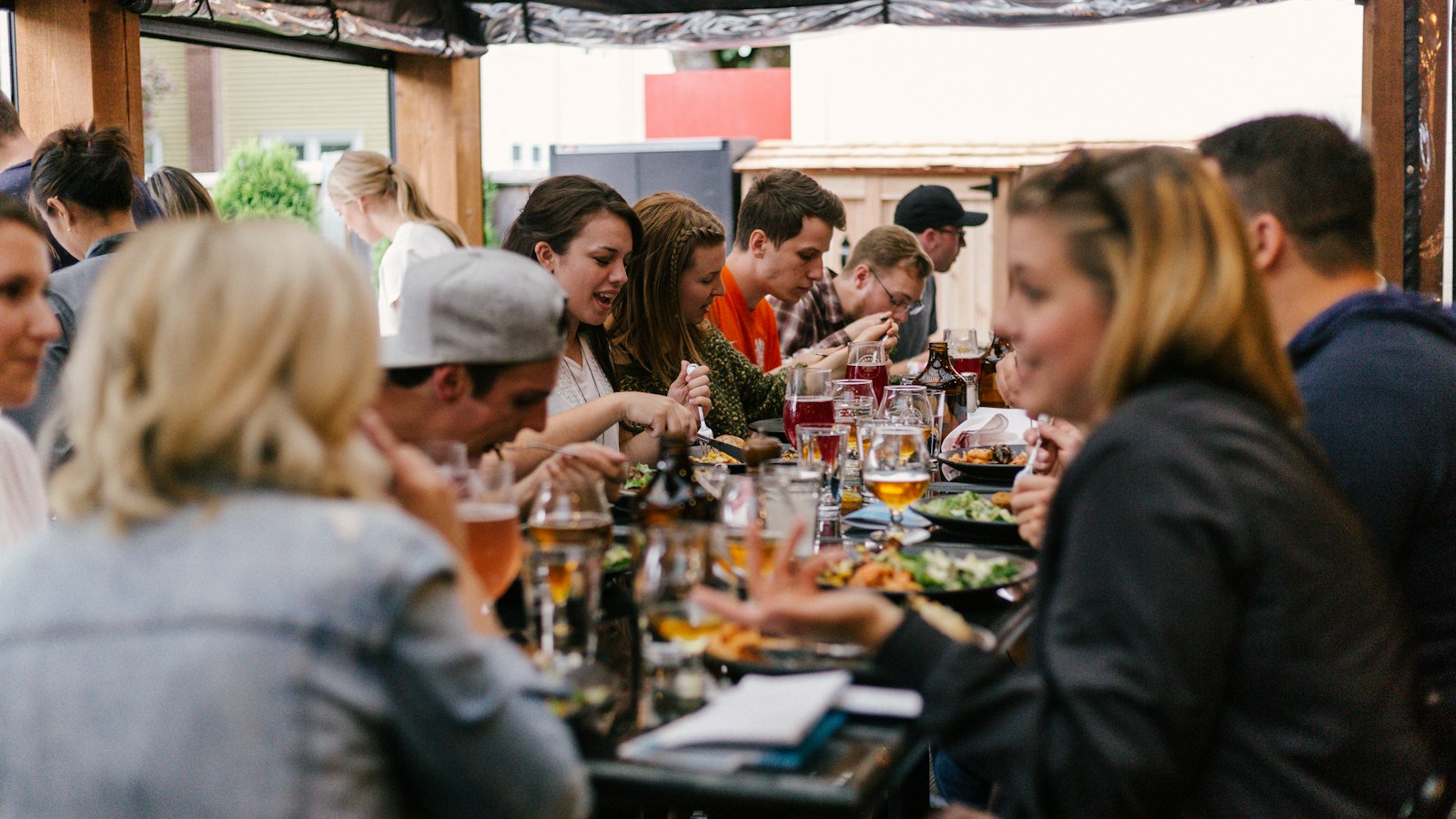 A group sharing a meal around a long table.
