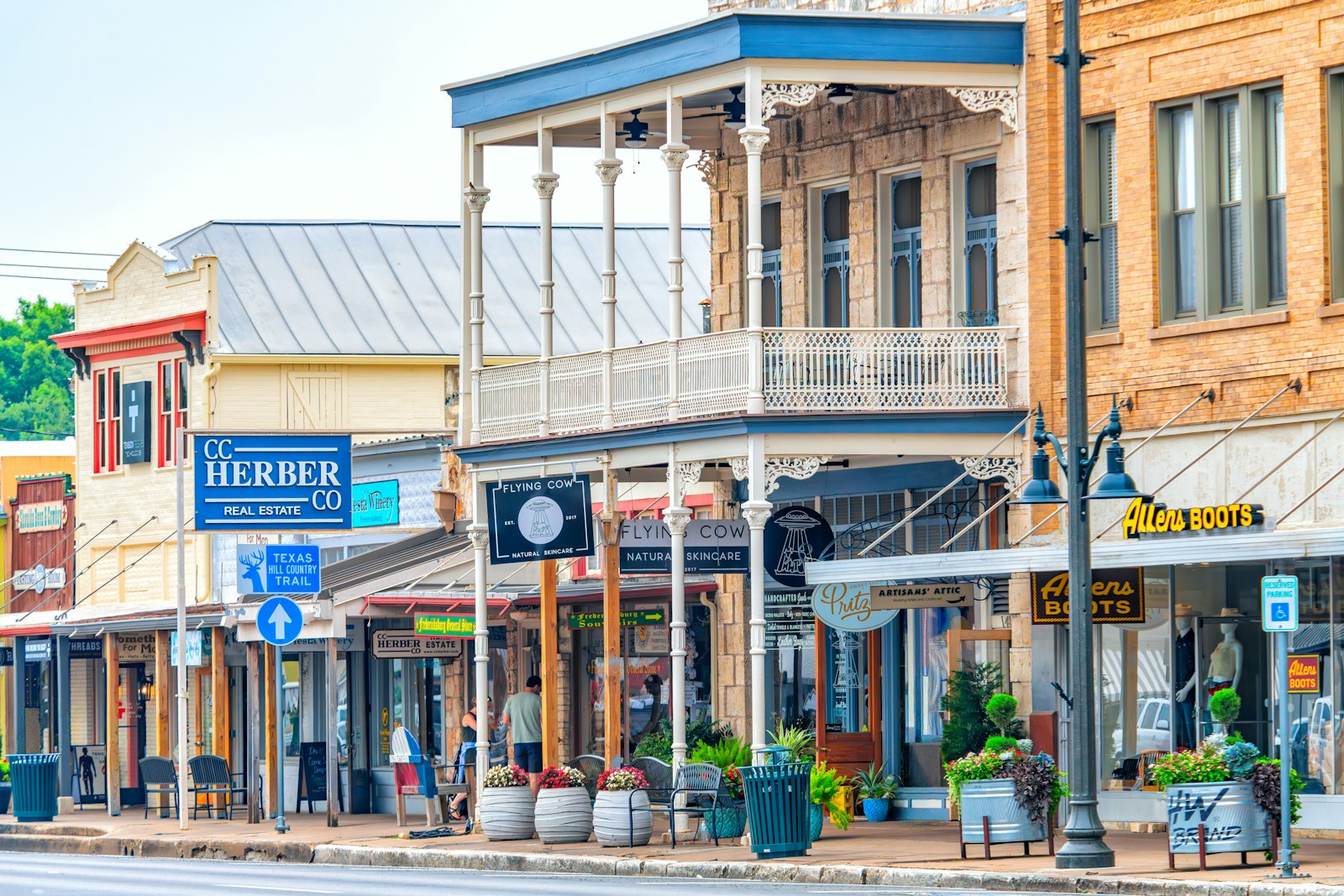 A short row of old plantation-era storefronts with deep awnings along a small-town street.