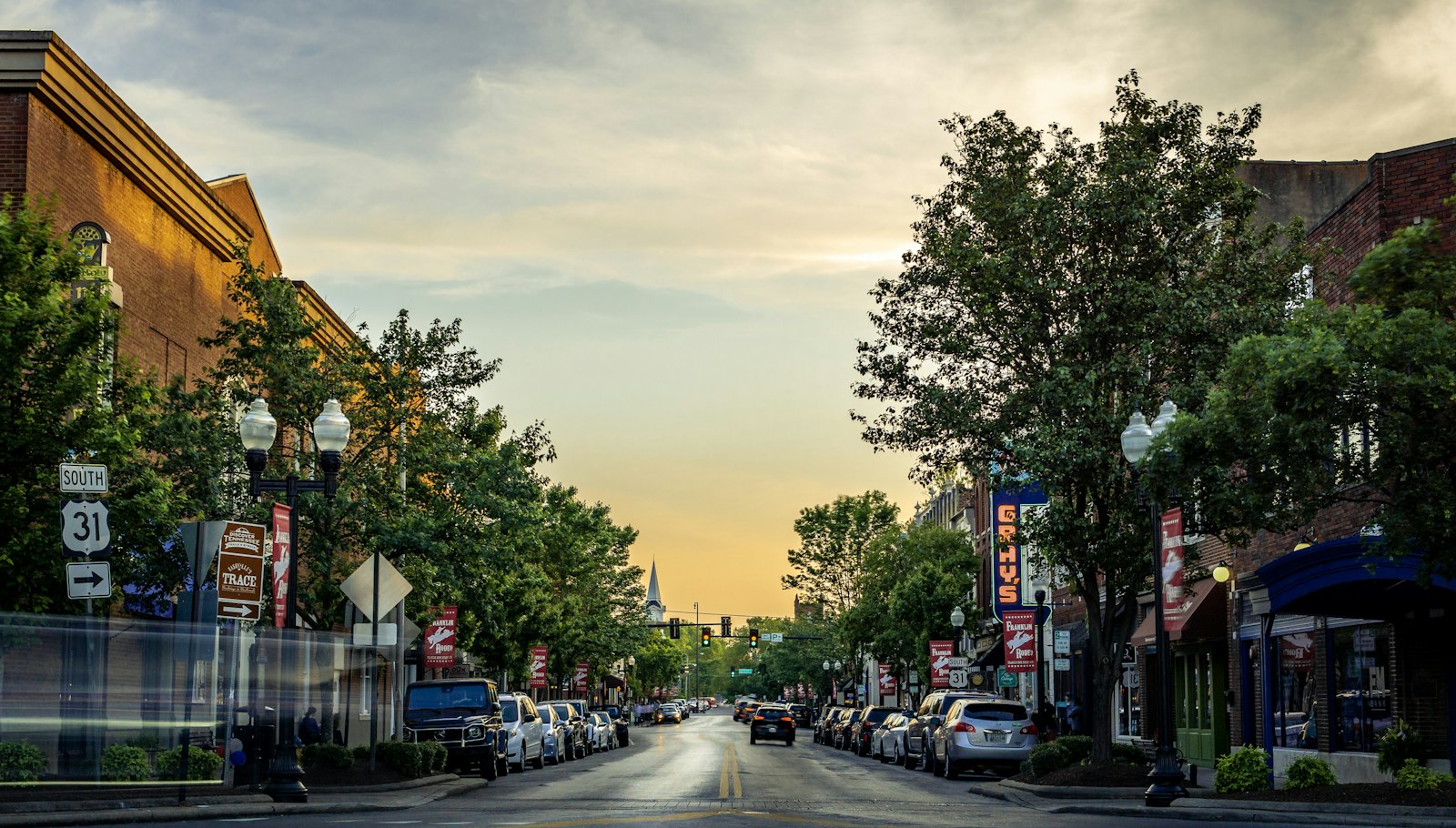 A small-town main street of shops at golden hour