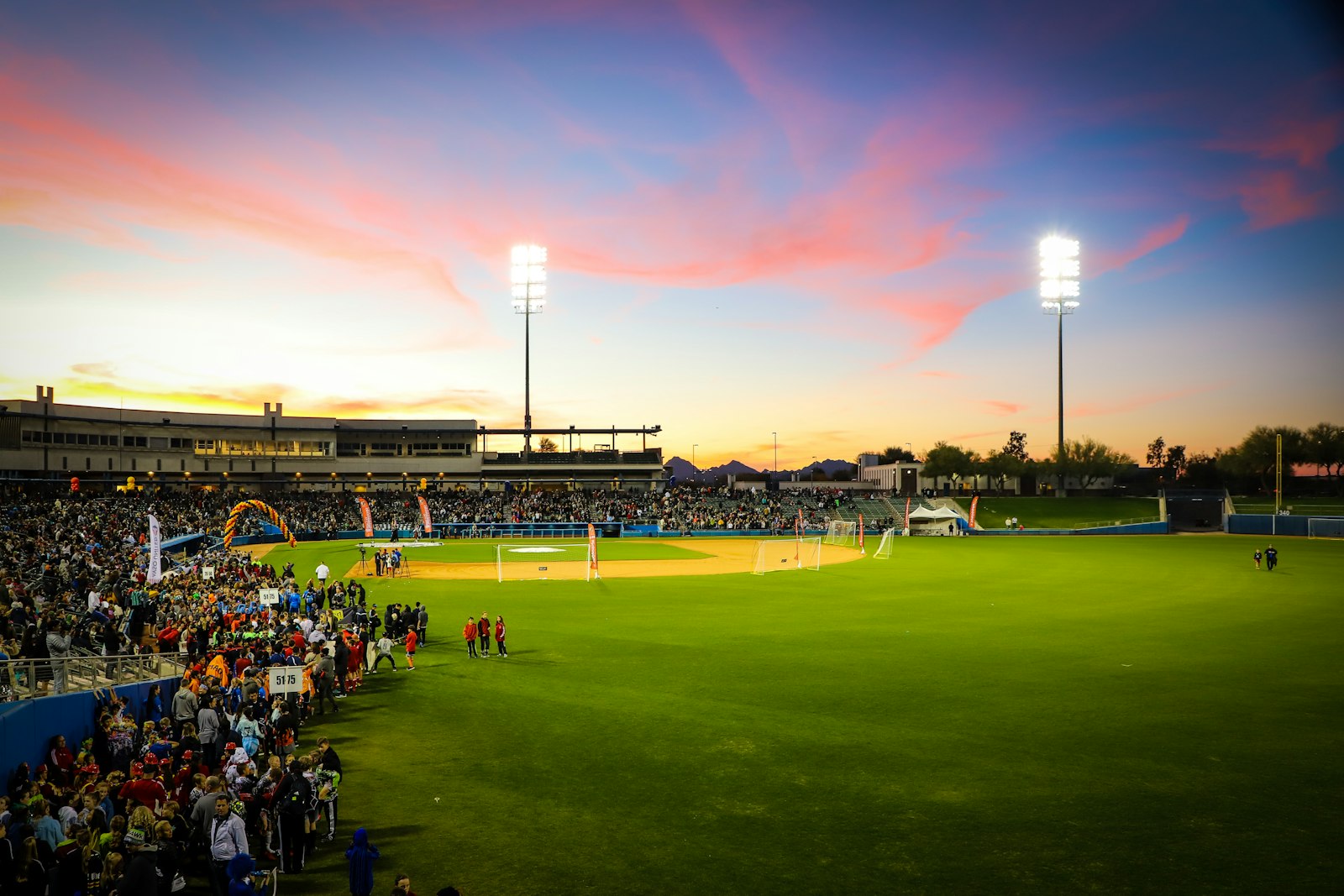 A ballfield under floodlights in the evening
